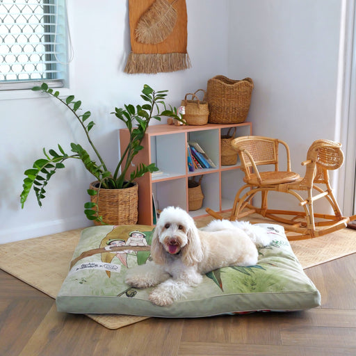 cute white dog lying on a huge luxurious dog bed in kids playroom showing earthy green gumnut babies may gibbs design in a modern home. australian linen blend dog cat and pet bed, washable and swappable bed covers