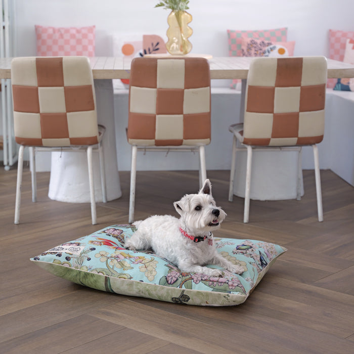 White west highland terrier sitting on a medium sized dog bed cover and pet bed with a sky blue gumnut babies design from May Gibbs