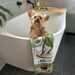 Cute dog in bath with iconic May Gibbs beach babies fur-free towel