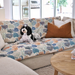 Dog sitting on a Coral Cove couch throw in a living room. Best couch protector Australia, designer prints, practical and beautiful
