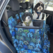Two cavoodles in dog car travel beds in small and large size with a matching car hammock seat cover